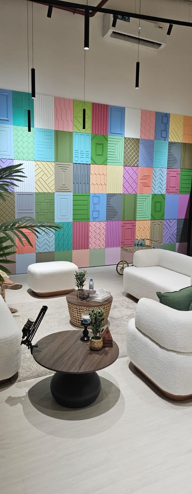 Lounge seating area with a bespoke multi-pattern joinery feature wall