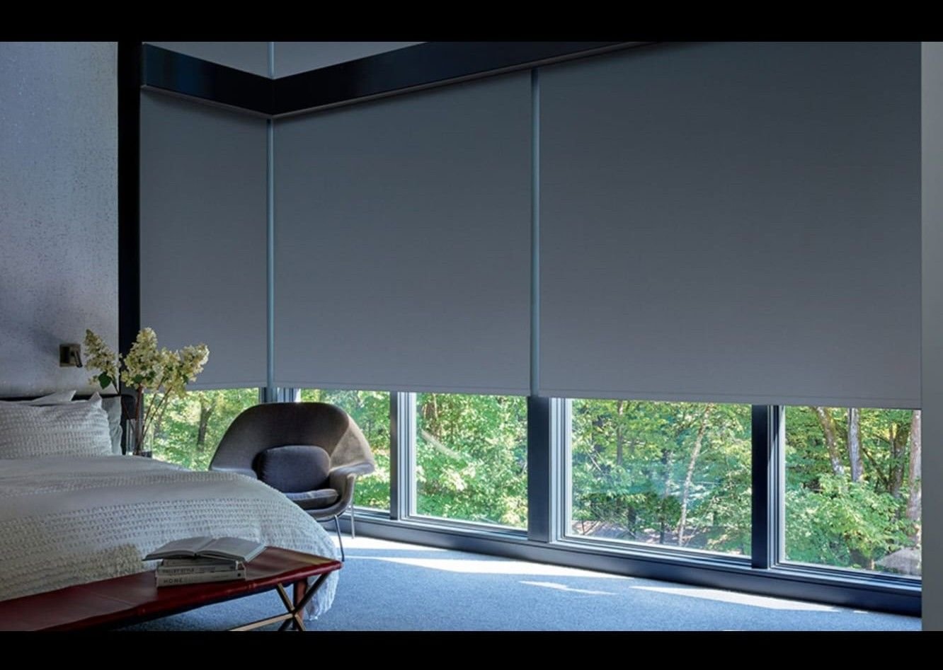 Bedroom fitted with motorised blackout roller shades