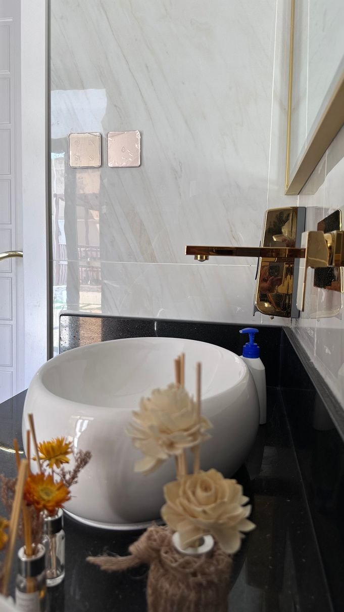 Marble bathroom vanity with a countertop basin and brass fittings