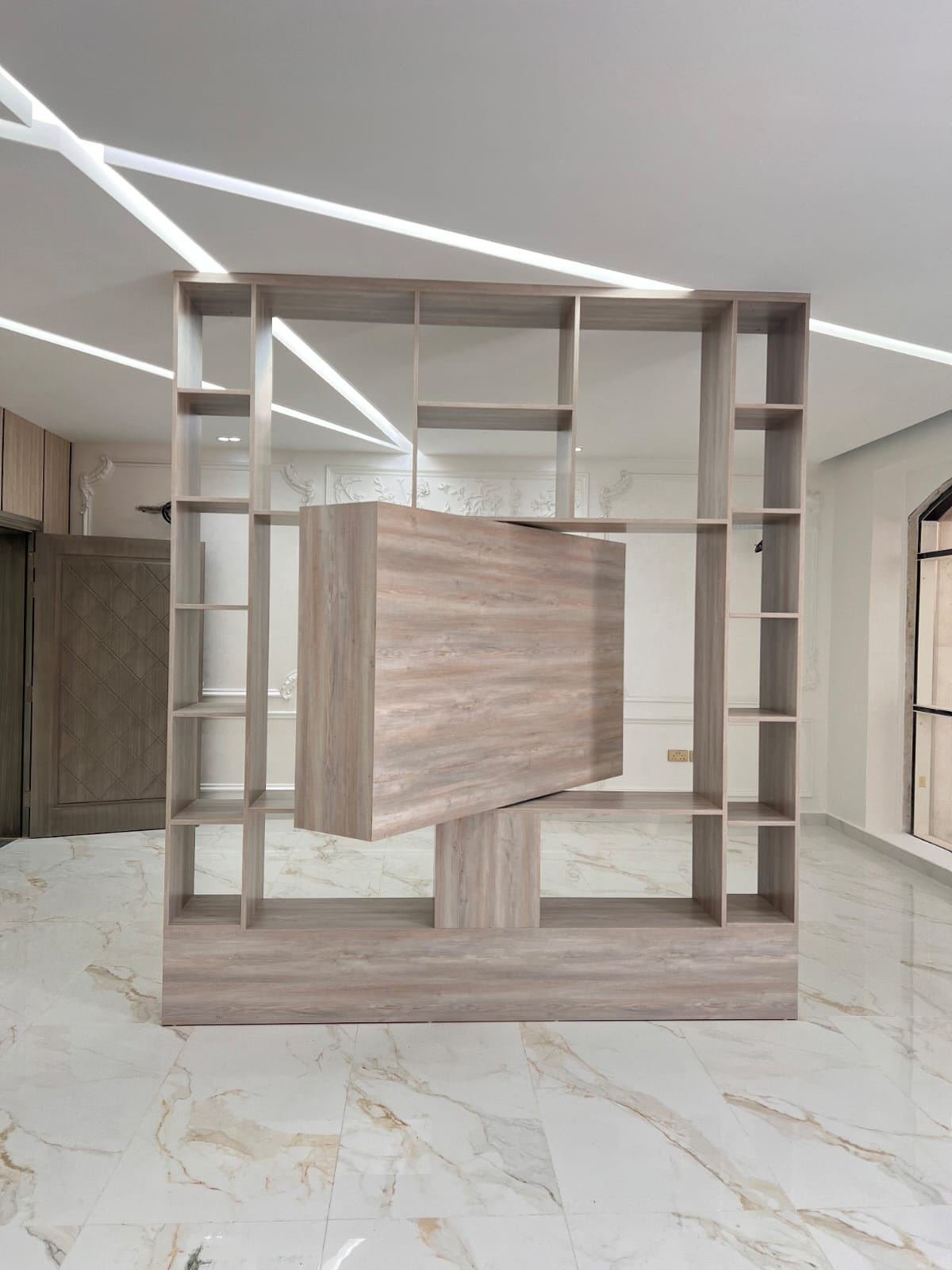 Open wood shelving unit used as a room divider