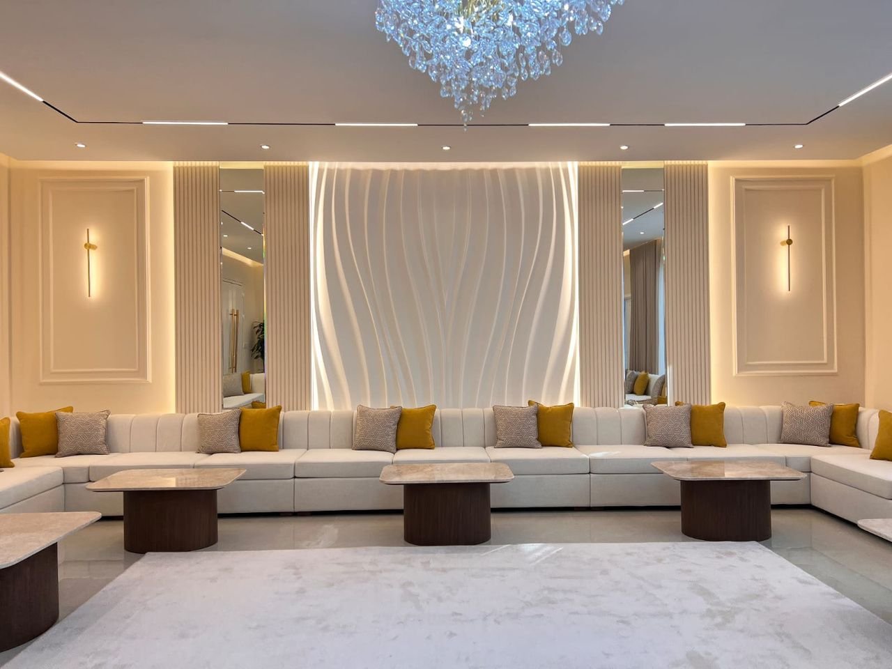 Majlis lounge with a backlit sculptural feature wall and fluted panelling