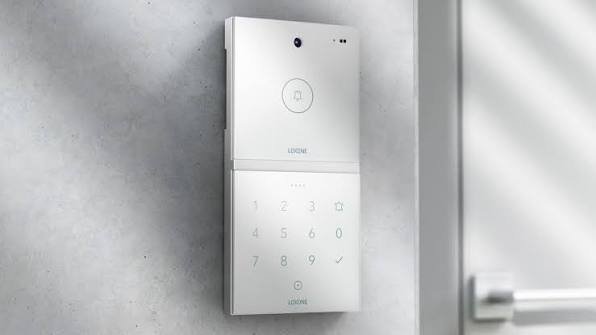 Modern video intercom panel with camera and keypad mounted at an entrance