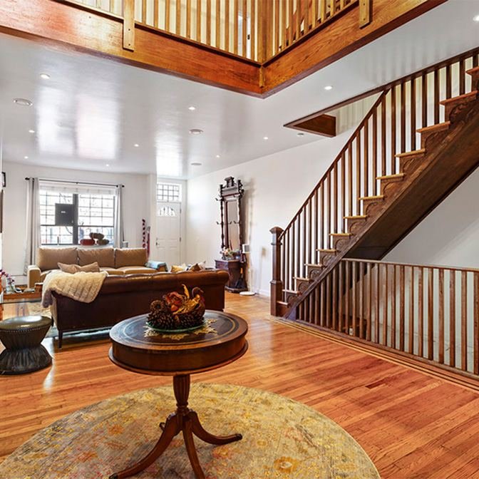 Living room with motorised curtains and staircase